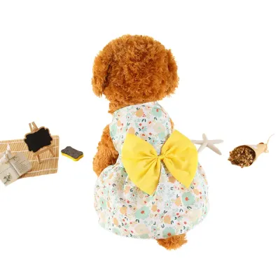 "Wholesale yellow floral dog dresses with bow accents – perfect for spring/summer pet fashion collections."