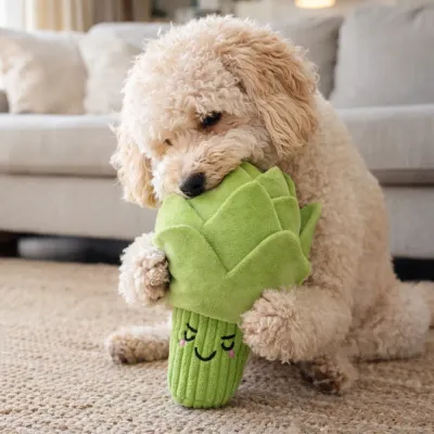 Cute puppy playing with artichoke plush dog toy indoor showing soft and interactive pet toy