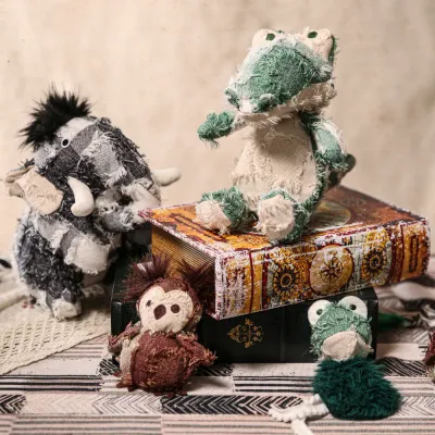 Hippie Series Plush Pet Toy Wholesale Collection A collection of hippie style plush toys including an alligator and a mammoth displayed on vintage books.