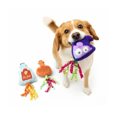 Dog holding Halloween plush potion toy with ribbon tails, showing interactive play and multi-pet usability