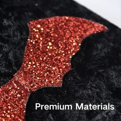 Premium Velvet Pet Costume Material Close-up with Glitter Detail close up of velvet pet costume fabric with red glitter bat wing detail soft material