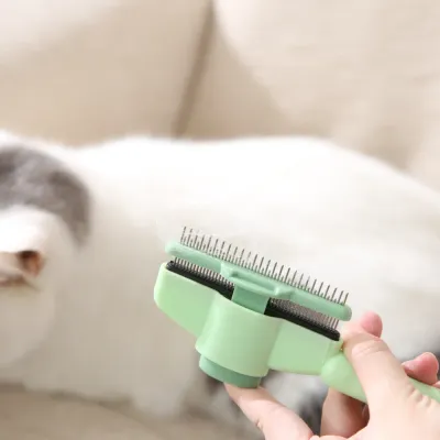 Close-up of the slicker brush with trapped pet hair being pushed forward by the self-cleaning plate.