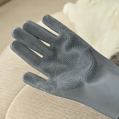 pet-hair-trapped-in-silicone-grooming-glove Close-up shot of a grey silicone glove covered in trapped pet hair after grooming.