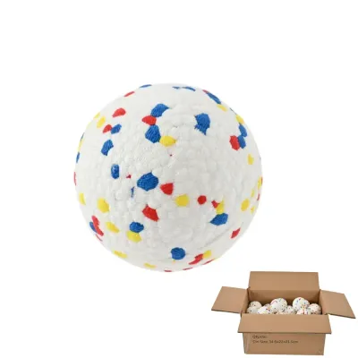 A single textured dog ball displayed next to a cardboard shipping box filled with multiple balls.