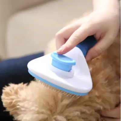 Professional self-cleaning slicker brush being used on a long-haired dog to remove loose fur.