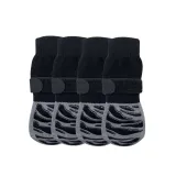 striped-print-breathable-dog-socks-4-pack A 4-pack of black and grey striped dog socks with thick rubberized tread and secure adjustable velcro fasteners.