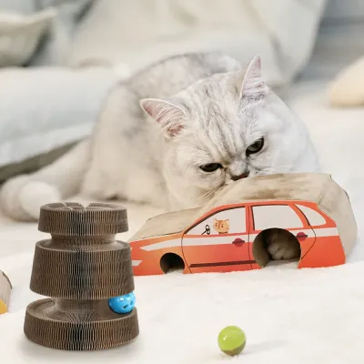 Indoor cat enjoying accordion cardboard cat scratcher with bell ball and magnetic car tunnel toy bulk wholesale