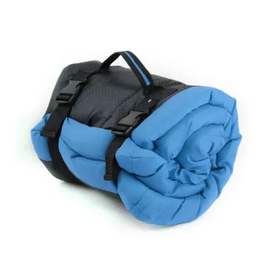 Blue-Portable-Dog-Sleeping-Pad Blue waterproof pet sleeping pad rolled and secured with straps for easy travel and storage.
