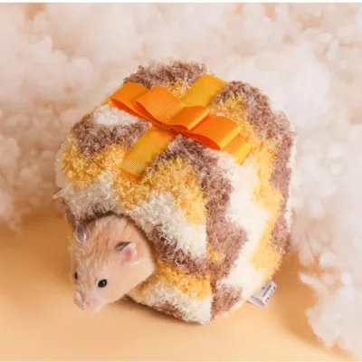 hamster-nest-gift-box-style-usage A hamster entering a yellow gift-box style plush nest on a soft white cloud-like background.