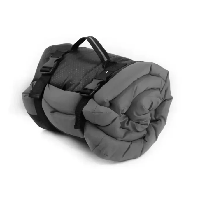 Grey-Foldable-Wholesale-Dog-Mat Grey bite-resistant dog mat rolled up into a portable cylinder with an integrated handle.