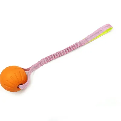 orange-floating-dog-ball-with-pink-bungee-rope Close-up of an orange textured dog ball with a light pink shock-absorbing bungee strap and handle.