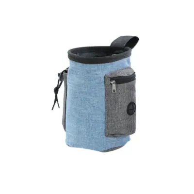 blue-fabric-pet-treat-bag-with-zipper Close-up of a blue fabric dog treat pouch featuring a gray zippered pocket and waste bag exit hole.