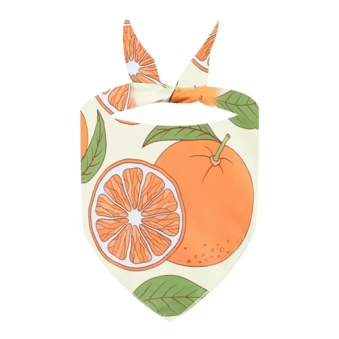 orange-and-leaf-print-dog-bandana Close-up of the "Orange" dog bandana featuring large whole oranges and slices with green leaves on a cream background.