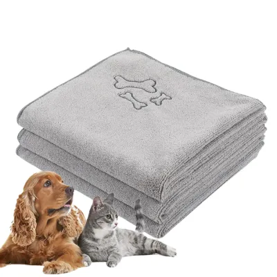 professional-microfiber-dog-towel-grey Stacked grey microfiber dog towels with bone embroidery, ideal for wholesale pet grooming supplies.
