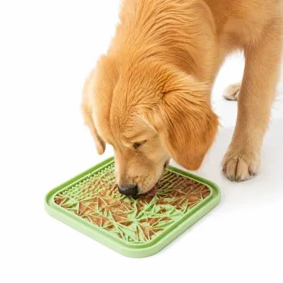 A Golden Retriever dog licking peanut butter from a green textured silicone slow feeder mat to reduce anxiety and fast eating.