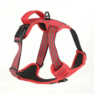 Side view of a red reflective dog harness showing the reinforced top control handle and quick-release buckle.