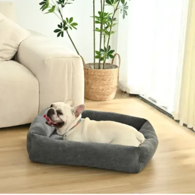 Cozy Indoor Pet Sofa Bed for Small Dogs in Living Room Scene | Petfairs small dog resting in soft black pet sofa bed placed in modern living room