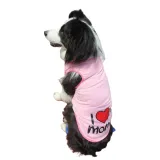 A black and white dog sitting and wearing a pink Mother's Day dog shirt with "I Love My Mommy" text and heart design.
