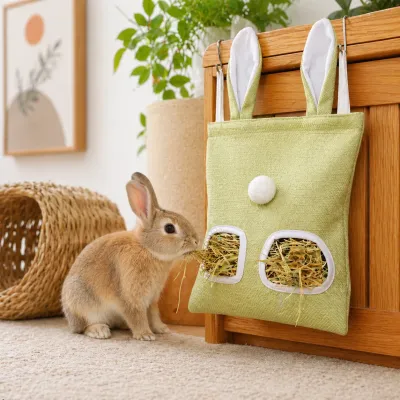 Rabbit Using Hanging Hay Feeder Bag Indoor Bunny Cage Foraging Toy Petfairs Indoor bunny eating hay from hanging rabbit hay feeder bag attached to wooden cage enrichment toy for rabbits