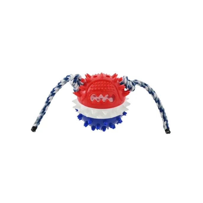 A red, white, and blue spiky rubber dog toy featuring a durable cotton rope for tugging.