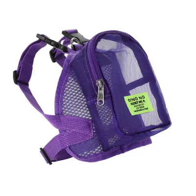 A purple adjustable mesh puppy backpack with zippered storage compartment and a bright green label.