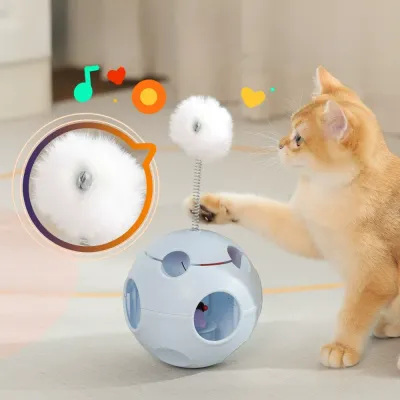 An orange tabby cat reaching out to swat at a white springy fluff ball attached to a blue interactive toy.