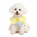 Small white dog wearing yellow ice silk bubble dress with breathable summer design for cats and small dogs