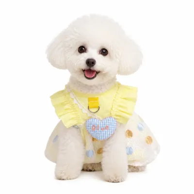 Small white dog wearing yellow ice silk bubble dress with breathable summer design for cats and small dogs