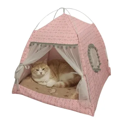 An orange and white cat resting comfortably inside a pink floral patterned pet tent with sheer white curtains.