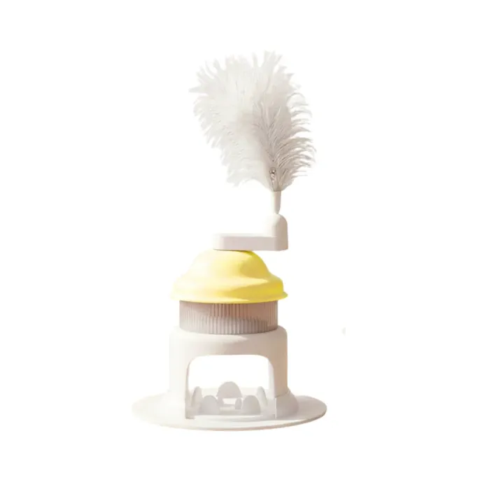 Yellow Interactive Cat Treat Dispenser Toy Yellow rotating cat treat dispenser toy with feather teaser isolated on white background