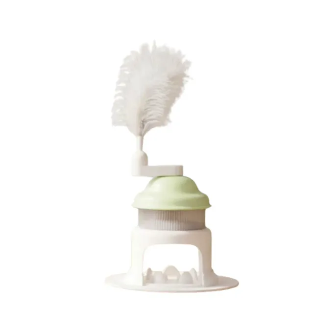 Green Interactive Cat Treat Dispenser Toy Green rotating cat treat dispenser toy with feather wand isolated on white background