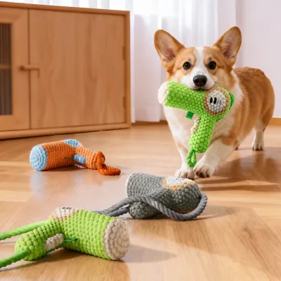 Dog Playing with Plush Hair Dryer Chew Toy Indoors Corgi dog carrying plush hair dryer chew toy in modern living room