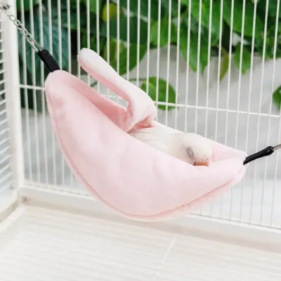 Cozy Banana Bird Hammock with Sleeping Bird Small bird resting comfortably inside a soft banana hanging hammock nest in a bird cage