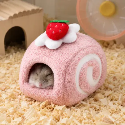 Sleeping hamster inside a pink strawberry-themed warm cotton hamster house