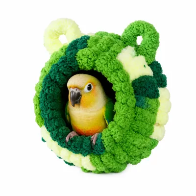 Green broccoli-shaped plush bird nest bed with parrot resting inside soft hanging hideout