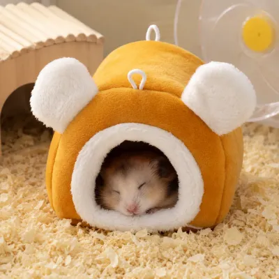 Hamster Sleeping Comfortably Inside Plush Cave Bed Cute hamster resting inside a warm plush hideout bed for small animals