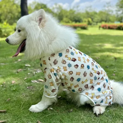 Large Dog Wearing Cooling Mesh Vest Outdoors Large white dog wearing breathable summer mesh vest while relaxing outdoors on grass