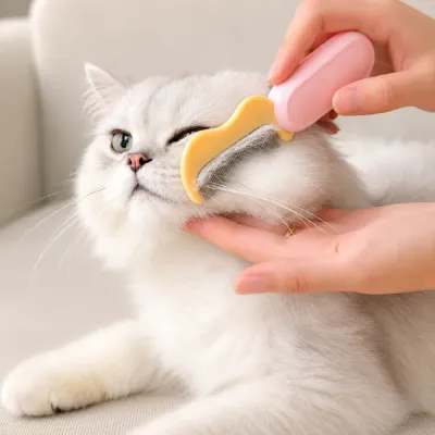 Cat being groomed with a foldable fine-tooth pet comb for removing loose hair
