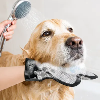 Dog being bathed using a pet grooming glove with soft silicone bristles