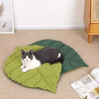 Cat Relaxing on Reversible Leaf Cat Mat Indoor cat resting on a reversible leaf shaped cat bed mat in a cozy living room