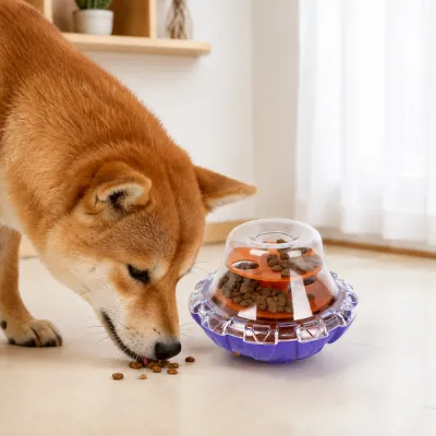 Dog Using Interactive Treat Dispensing Puzzle Toy Dog enjoying kibble from an interactive slow feeder puzzle toy at home