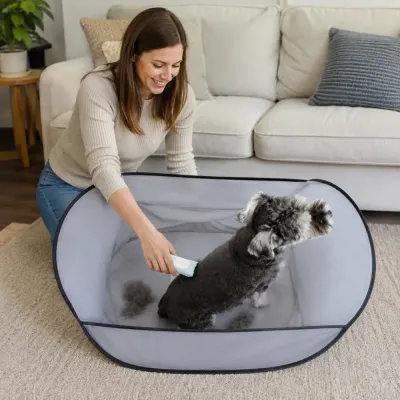 Dog Grooming Hair Catcher Apron in Living Room Woman grooming a dog inside a pet hair collecting apron to reduce shedding mess in the home