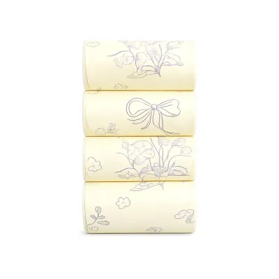 yellow-degradable-scented-dog-poop-bags-4-rolls Four rolls of yellow degradable scented dog poop bags with elegant floral and bow patterns stacked vertically.