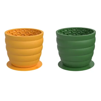 Yellow and Green Silicone Dog Slow Feeder Cups Yellow and green silicone honeycomb dog slow feeder cups with suction bases on white background