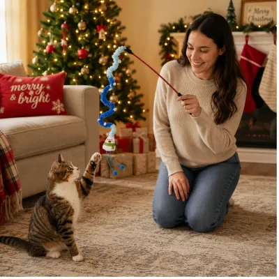Cat Playing with Christmas Plush Teaser Wand Cat playing with blue Christmas plush teaser wand in decorated holiday living room