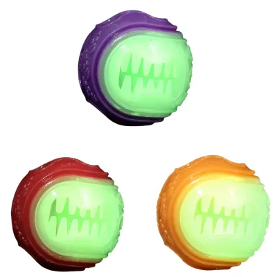 Glow in the Dark Dog Treat Ball Color Options Purple, red and orange glow in the dark dog treat balls on white background