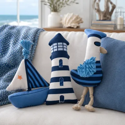 Blue and white nautical dog plush toys displayed on a sofa in a coastal home setting