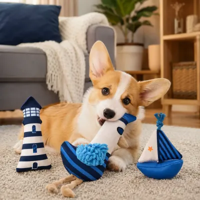 Corgi dog playing indoors with sailboat, seagull and lighthouse plush toys