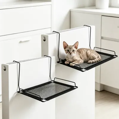 Kitten resting on black breathable mesh cat hammock mounted on radiator in a clean indoor room