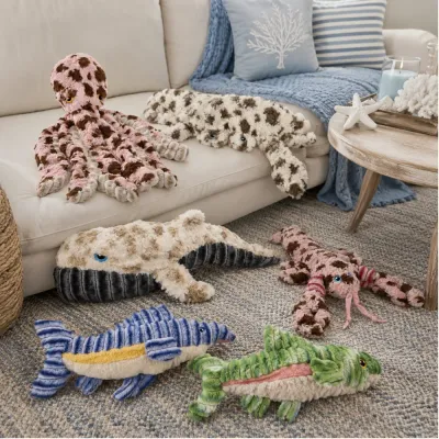 Ocean Plush Dog Toy Collection Display Ocean-themed dog plush toys displayed in a coastal living room scene